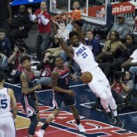 Joel Embiid dunking during a game verus the Washington Wizards