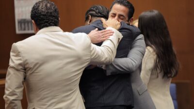 A$AP Rocky hugging his legal team