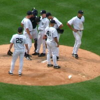 Multiple Yankee players gathering at the mound